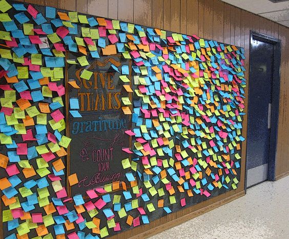 A prayer wall with sticky notes adds lots of color to the space